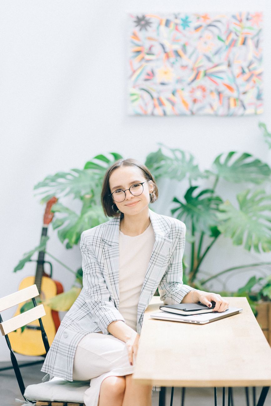 Smiling woman in glasses at her desk