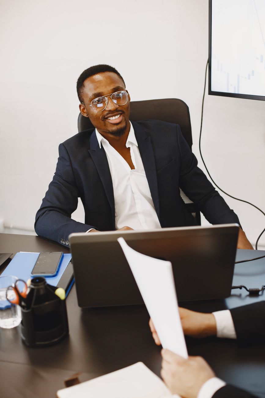 Businessman smiling at his laptop